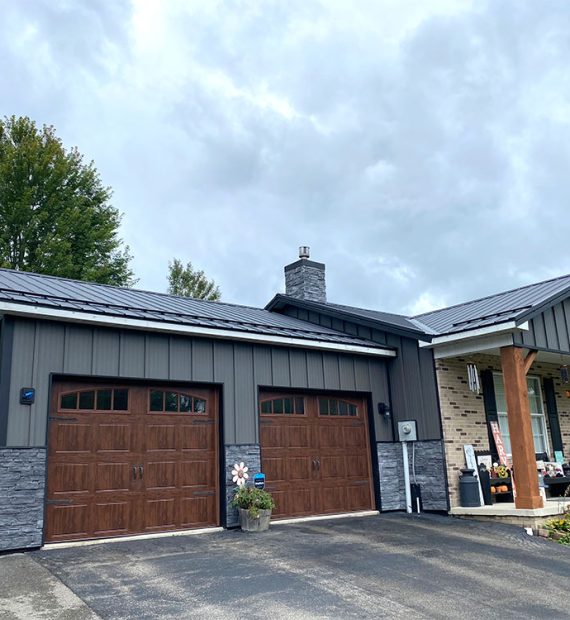 Home with metal board and batten and metal roof by Deep Creek Metal